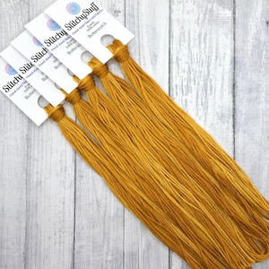 May include: Five spools of hand-dyed embroidery floss in a warm golden yellow color called "Butterscotch". The floss is 100% cotton and each spool contains 8 yards.