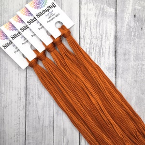May include: Five spools of hand-dyed 100% cotton embroidery floss in a warm orange color called "Pumpkin Spice".