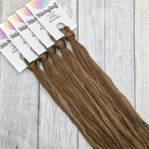 May include: Five skeins of brown hand-dyed 100% cotton embroidery floss, labeled "StitchyStuff" and "Brown Bear".