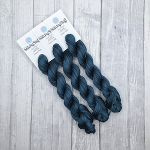May include: Three skeins of hand-dyed yarn in a deep blue color called "Lunar Tide". Each skein is 100 yards of cotton yarn.