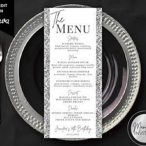 May include: A vertical rectangular menu card with silver glitter borders and black text. The header reads The Menu, followed by sections for Starters, Main, Dessert, and Drinks. The bottom includes the text Jennifer's 50th Birthday and 08.15.20XX.
