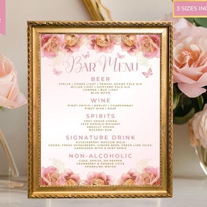 May include: A printable pink and gold bar menu with floral accents. The menu lists beer, wine, spirits, a signature drink, and non-alcoholic options. The text reads "Bar Menu".