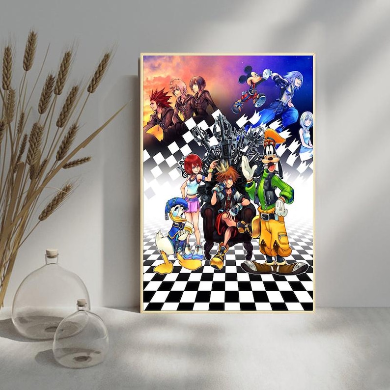 May include: Framed artwork featuring characters from the Kingdom Hearts video game series. The artwork showcases a variety of characters, including Sora, Donald Duck, Goofy, and Mickey Mouse, set against a checkered background.