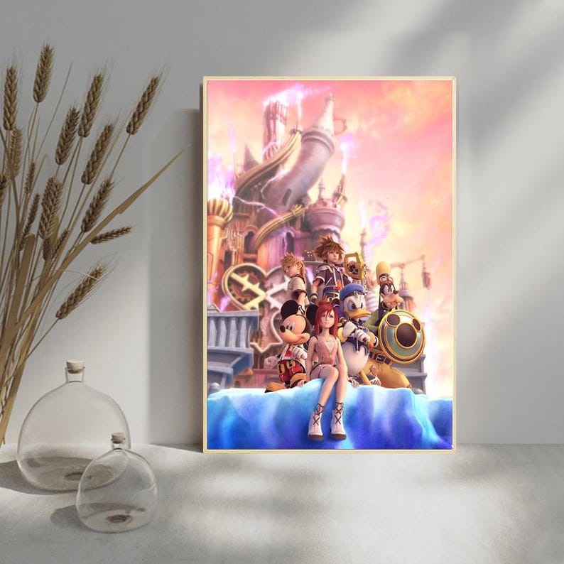 May include: A framed print featuring characters from the Kingdom Hearts video game series. The artwork depicts a castle in the background with several characters in the foreground, including Mickey Mouse, Donald Duck, and Sora. The color palette includes pinks, blues, and golds.