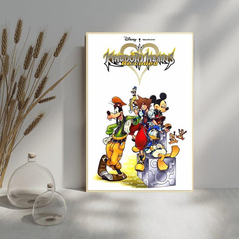 May include: A framed poster featuring characters from the Kingdom Hearts Re:coded video game. The artwork includes Goofy, Sora, Mickey Mouse, Donald Duck, and other characters. The title "Kingdom Hearts Re:coded" is displayed at the top of the poster.