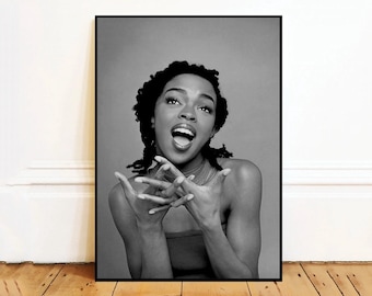 May include: Black and white portrait photograph of a woman with short, curly hair. She is smiling and looking at the camera.