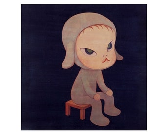 May include: A gray, cartoon-like figure with a large head and small body sits on a wooden stool. The figure has a gray hooded head with large ears and a small, round face with a serious expression. The figure is wearing a gray, hooded outfit.