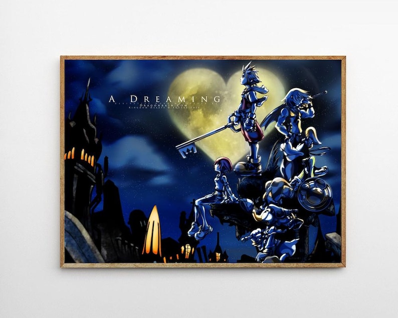 May include: A framed art print featuring a fantasy scene with characters and a key-shaped weapon. The artwork is set against a night sky with a heart-shaped moon. The text "A DREAMING" is visible at the top.