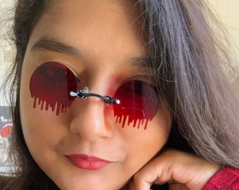 Tropfende geschmolzene runde rote Pince-nez Gläser