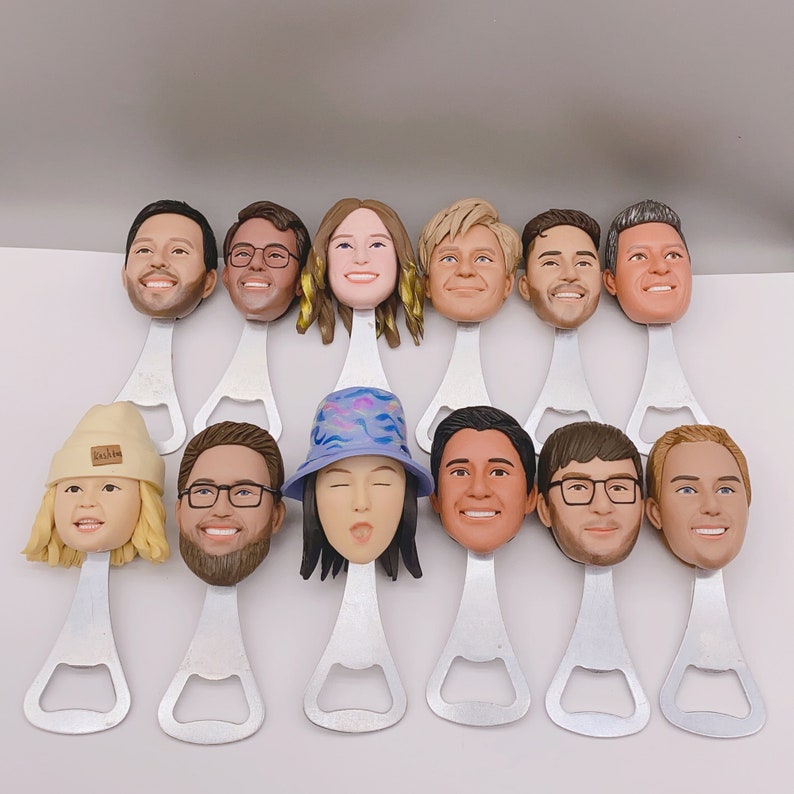 May include: A set of 12 bottle openers featuring different faces. Each opener is made of metal and has a silver finish. The faces are all different and have unique expressions.