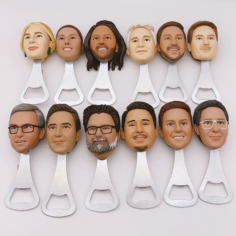 May include: Set of 12 bottle openers featuring different faces. Each opener is made of metal and has a silver finish. The faces are all different and have a realistic look.