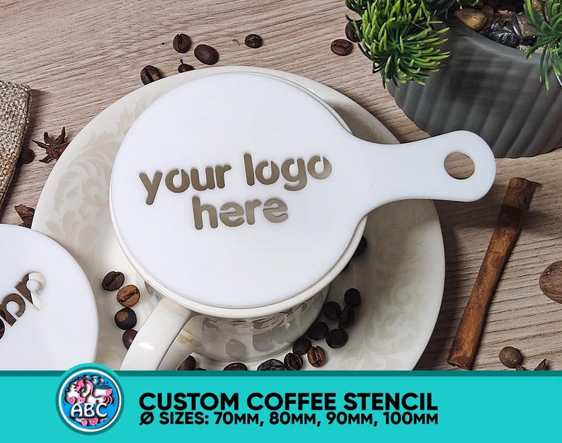 May include: White plastic coffee stencil with a handle. The stencil has the text "your logo here" printed on it. The stencil is on a white saucer with coffee beans around it. The stencil is available in sizes 70mm, 80mm, 90mm, and 100mm.