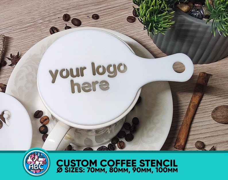 May include: White coffee stencil with a handle. The stencil says "your logo here". The stencil is on a white mug with coffee beans around it. The stencil is available in sizes 70mm, 80mm, 90mm, and 100mm.
