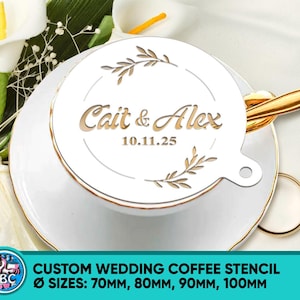 May include: A white custom wedding coffee stencil with the names "Cait & Alex" and the date "10.11.25" in a decorative font. The stencil is placed on a white teacup and saucer with gold trim. The stencil sizes are 70mm, 80mm, 90mm, and 100mm.