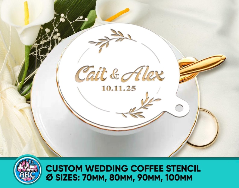 May include: A white custom wedding coffee stencil with the names "Cait & Alex" and the date "10.11.25" in a decorative font. The stencil is placed on a white teacup and saucer with gold trim. The stencil sizes are 70mm, 80mm, 90mm, and 100mm.