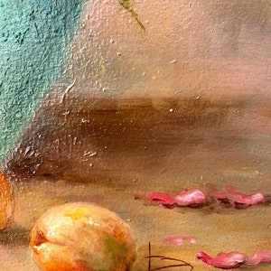 May include: A still life painting of a peach, pink flower petals, and a vase. The vase is a teal blue color and the peach is a light orange color. The painting is signed with the letter "B" and the year "2021".