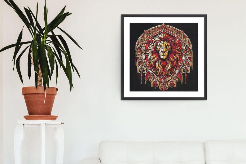 May include: A framed art print depicting a lion's head in red and gold tones, set against a black backdrop. The lion is the focal point of an elaborate, shield-shaped design. The artwork is displayed on a white wall, next to a potted plant.