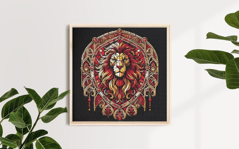 May include: Framed artwork depicting a lion's head in a stained-glass style. The lion has a red and gold mane, set against a black background. The frame is a light wood colour, and the artwork is a square shape.