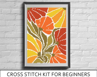 May include: A framed cross stitch pattern featuring a floral design with large petals in shades of red, orange, and yellow, accented by olive green leaves. The text below reads: CROSS STITCH KIT FOR BEGINNERS (CANVA+THREADS+PRINTED PATTERN).