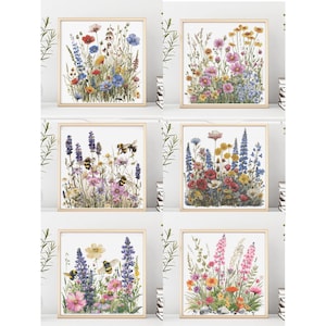 Puede incluir: Seis impresiones artísticas florales enmarcadas con pinturas de acuarela de flores silvestres en varios colores, incluyendo amapolas rojas, acianos azules y cosmos rosas. Algunas impresiones incluyen abejas. La obra de arte está sobre un fondo blanco.