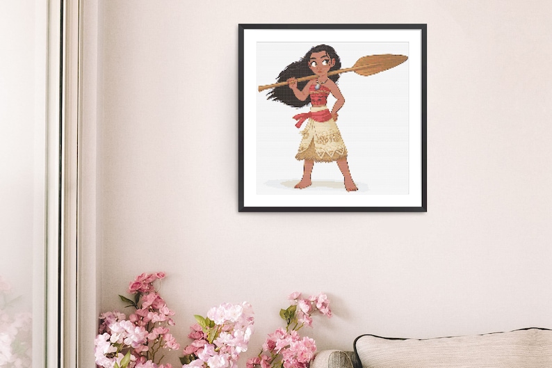 May include: A framed pixel art print depicting a Polynesian woman with a wooden oar. She is dressed in a red top, a tan skirt, and a necklace. The artwork is set against a white background within a black frame.