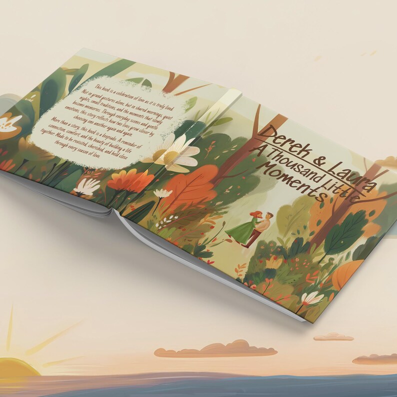 May include: An open hardcover book featuring a whimsical illustration of a couple in a forest. The cover text reads Derek & Laura A Thousand Little Moments. The back cover includes a printed paragraph about love, connection, and shared memories.