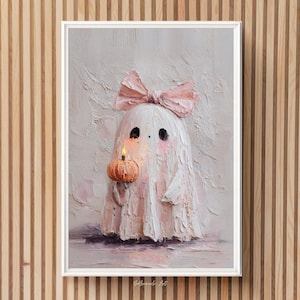 May include: A framed painting of a friendly ghost holding a pumpkin candle. The ghost is white with a pink bow and blush. The pumpkin is orange with a lit candle. The background is textured with pink and white paint.