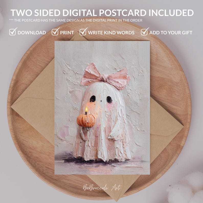 May include: A digital postcard featuring a cute ghost with a pink bow, holding a pumpkin with a lit candle. The postcard is on a wooden tray with a brown envelope. Text on the postcard reads "TWO SIDED DIGITAL POSTCARD INCLUDED".