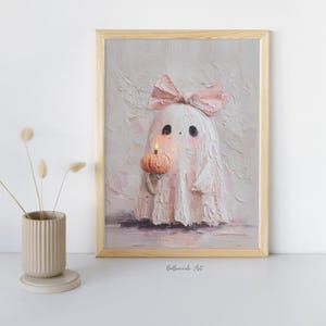 May include: A framed painting of a ghost with a pink bow, holding a small pumpkin with a lit candle. The ghost is white with black eyes and pink cheeks. The artwork has a textured, impasto style.