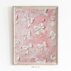 May include: A pink canvas painting featuring white 3D bows. The bows are arranged in a random pattern across the canvas. The painting has a textured, brushstroke effect.