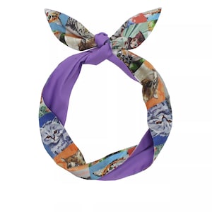 May include: Purple headband with a cat print design. The headband is tied in a knot at the top.