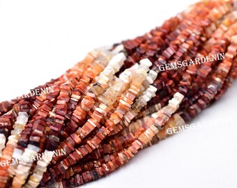 May include: A strand of red, orange, and white gemstone beads. The beads are square and have a rough, natural finish. The beads are strung on a clear string. The strand is about 18 inches long.  "GEMSGARDENIN" is printed on the beads.