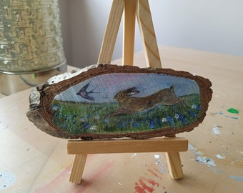 Hare painted on a wood slice