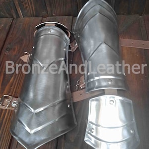 pair of steel bracers with palms