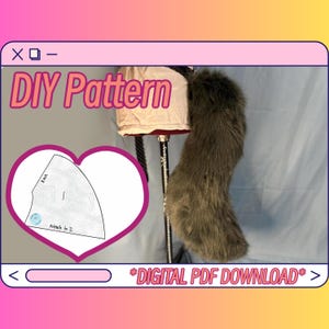 May include: DIY pattern for a furry tail. The pattern is in the shape of a heart and includes instructions to attach to a base. The tail is shown on a mannequin. The text "DIY Pattern" and "*DIGITAL PDF DOWNLOAD*" is visible on the image.