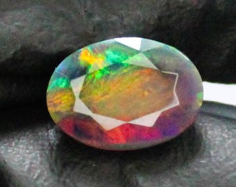 Faceted Black Opal: Oval Gemstone with Red Fire (1.69 Carats, 10x7x5 mm