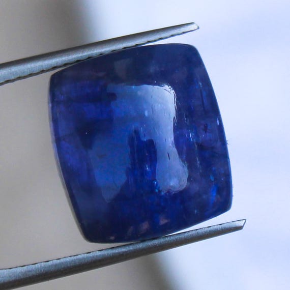 Natural Blue Tanzanite Cabochon: 13.50 Carat In Cushion Shape Gemstone, 14x12x7 mm