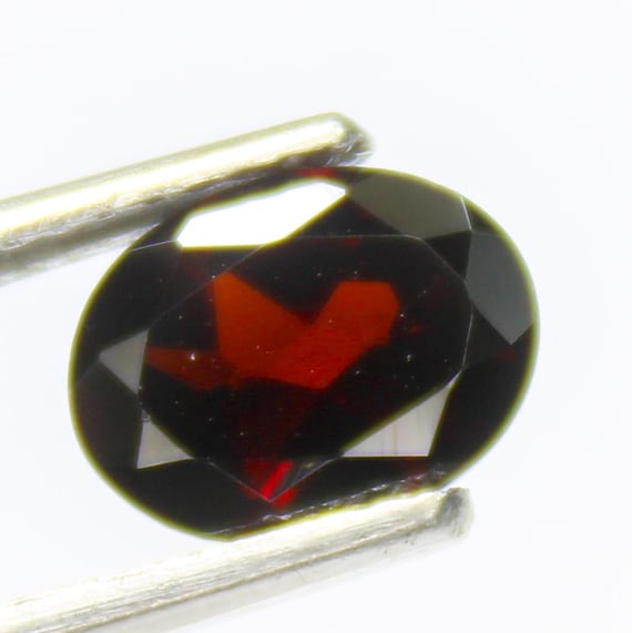 Faceted Red Mozambique Garnet: Oval Gemstone for Jewelry Making (1.45 Carats, 8x6x3 mm)