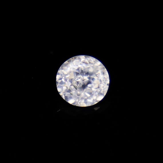 Faceted White Zircon: 1.40 Carat Round Gemstone, 6x6x4 mm