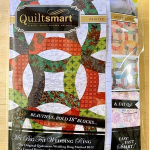 May include: Quiltsmart pattern for a wedding ring quilt with a printed fabric design. The pattern includes instructions for making 18-inch blocks and uses a clever appliqué method. The text on the package reads "My Big Fat Wedding Ring" and "Easy! Fast! Smart!"