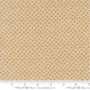 May include: Tan fabric with a repeating pattern of small, red floral designs. The fabric has a vintage aesthetic, with a ruler along the bottom edge. The pattern is evenly distributed across the surface.