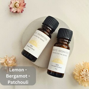 May include: Two amber glass bottles with black lids, labelled "MICKI'S AROMATICS SCENTS FOR THE SENSES" and "ZEN Essential Oil Blend 10ml".