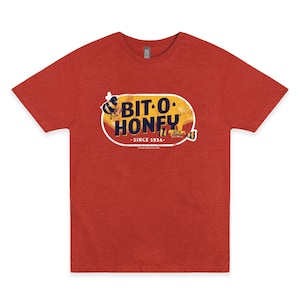 May include: Red t-shirt with a vintage-style logo for Bit-O-Honey. The logo features a yellow honeycomb design with bees and the text "Bit-O-Honey" in white with a black outline. The text "Since 1924" is also included in the logo.
