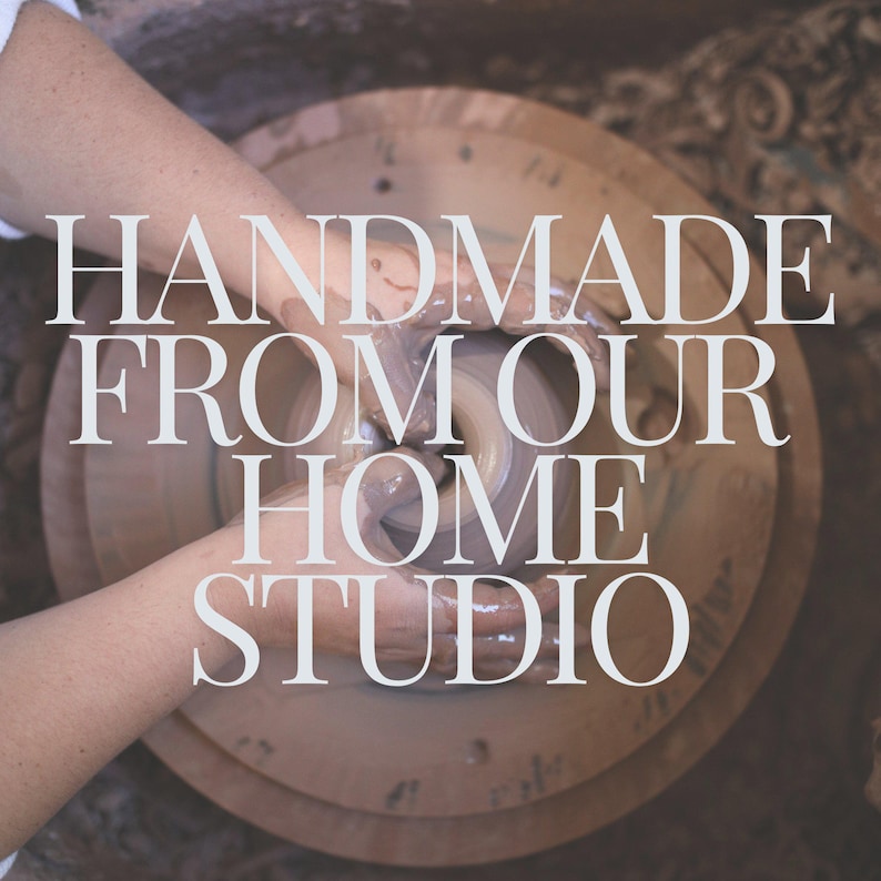 May include: A pair of hands are shaping a lump of clay on a pottery wheel. The text "HANDMADE FROM OUR HOME STUDIO" is superimposed on the image.