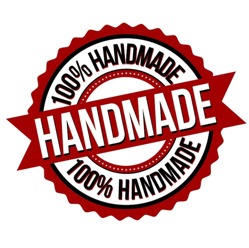 May include: Red and black circular stamp with the text "100% HANDMADE" and a red ribbon with the text "HANDMADE" across the center.