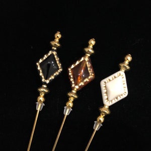 Black, amber or cream and gold hatpins in a choice of lengths