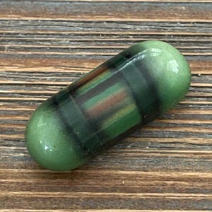 May include: A white ceramic mug with a black handle and the text "But First, Coffee" in a black, handwritten-style font. The mug is on a white surface.