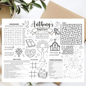 May include: A black and white activity sheet for a baptism, featuring a crossword puzzle, maze, word scramble, and other games. The sheet includes the text "Anthony's Baptism" and religious imagery such as a cross, church, and angel.