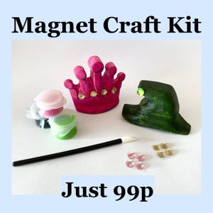 May include: A magnet craft kit with a pink crown, green witch hat, paint pots, a paintbrush, and decorative gems. The text "Magnet Craft Kit" is at the top of the image.