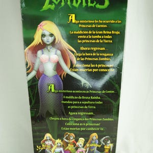 May include: A Princesas Zombies toy packaging featuring a mermaid doll with long blonde hair, a pink seashell top, and a purple tail. The green background displays text in Spanish and Portuguese, along with images of six different doll characters.